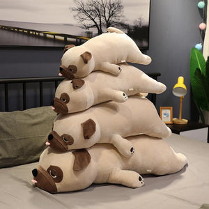 Image of four Pug stuffed animals soft plush toys of diferent sizes lying on the bed