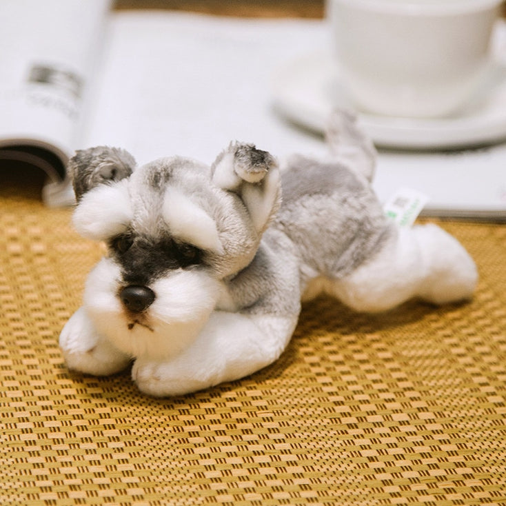 image of an adorable schnauzer stuffed animal plush toy sitting on a mat