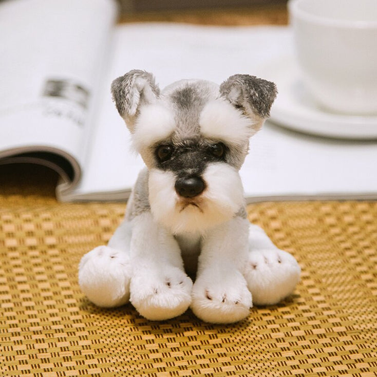 image of an adorable schnauzer stuffed animal plush toy sitting on a mat