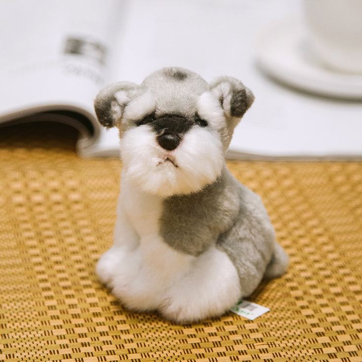 image of an adorable schnauzer stuffed animal plush toy sitting on a mat