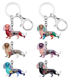 Image of six dachsund keychains in different colors, made of enamel