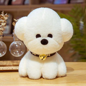 This image shows a cute sitting Bichon Frise Stuffed Animal Plush Toy with a black collar-bell in it's neck and sitting on the table.