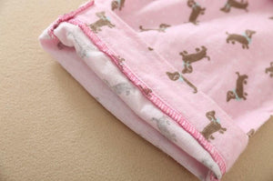 Image of a pink color Dachshund Pajama set sleeves close view with an infinite dachshund print design