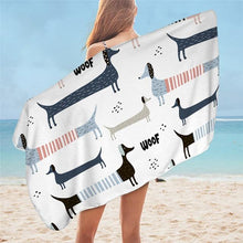 Load image into Gallery viewer, Image of a girl holding a dachshund towel on a beach with dachshunds on white background on it
