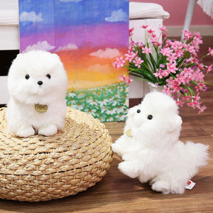 image of two pomeranian plush toys playing together 