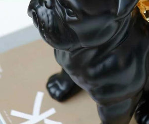 Close up image of a black french bulldog ceramic statue with gold-plated angel wings