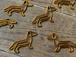 image of dachshund paperclips on wooden table