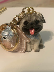 Image of a smiling Pug keychain in 3D Pug design