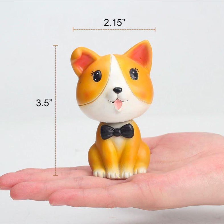 Image of a nodding Corgi bobblehead on the hand of a person