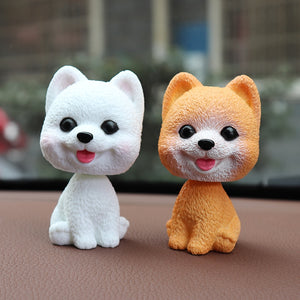 Image of a pomeranian bobbleheads in the color white and orange