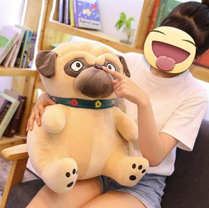 Image of a girl sitting on a couch holding a Pug stuffed animal soft toy