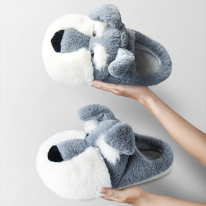Image of a person holding schnauzer slippers with open heel