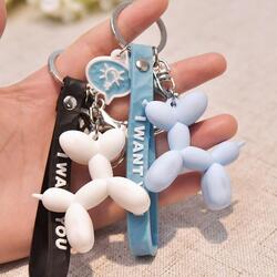 Image of two super cute balloon Poodle keychains for Poodle dog gift lovers