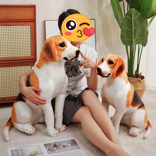 Load image into Gallery viewer, A person sitting on the floor in a styled room holds and poses with two large plush beagle dog toys. One dog is large and upright while the other is seated beside them.