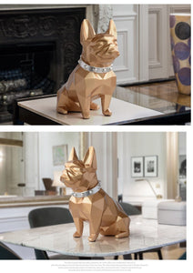 Image of a collage of two super-cute French Bulldog statues which is also a piggy bank in gold color, placed on a table