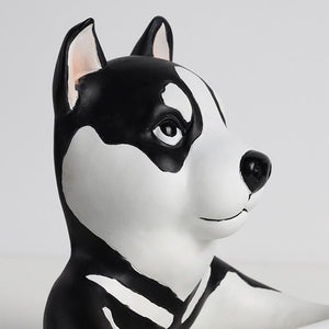 Close image of a super cute black and white husky toilet paper holder