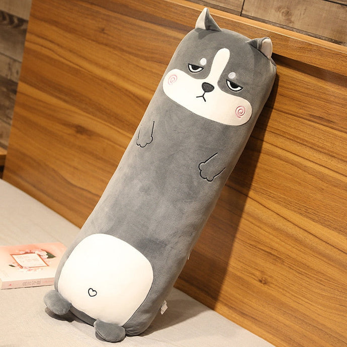 This image shows a Husky stuffed animal plush pillow leaning towards the wall.