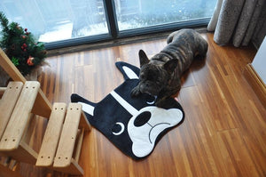 Image of a dog sitting on a Boston Terrier floor rug or mat lying on the floor, shaped like cute Boston Terrier face