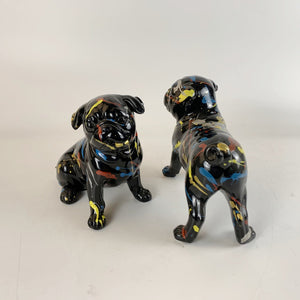 Image of standing and sitting black pug statues
