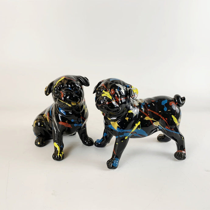 Image of two black pug statues
