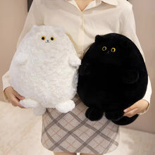 Load image into Gallery viewer, A person wearing a cream button-up shirt and a beige plaid skirt holds two round plush cat toys, one white and one black, both with embroidered yellow eyes and small black and beige facial details.