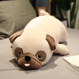 Image of a Pug stuffed animal soft toy lying on the bed