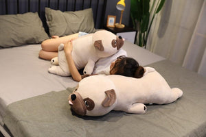 Image of a girl on the bed sleeping with two Pug stuffed animals soft plush toys