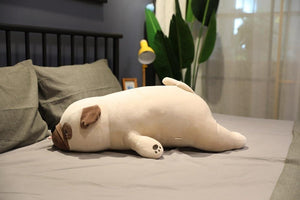 Image of a Pug stuffed animal lying on the bed