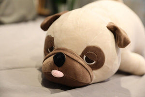Image of a Pug stuffed animal soft plush toy lying on the bed