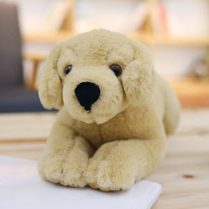 image of a light brown labrador stuffed animal plush toy sleeping on a table