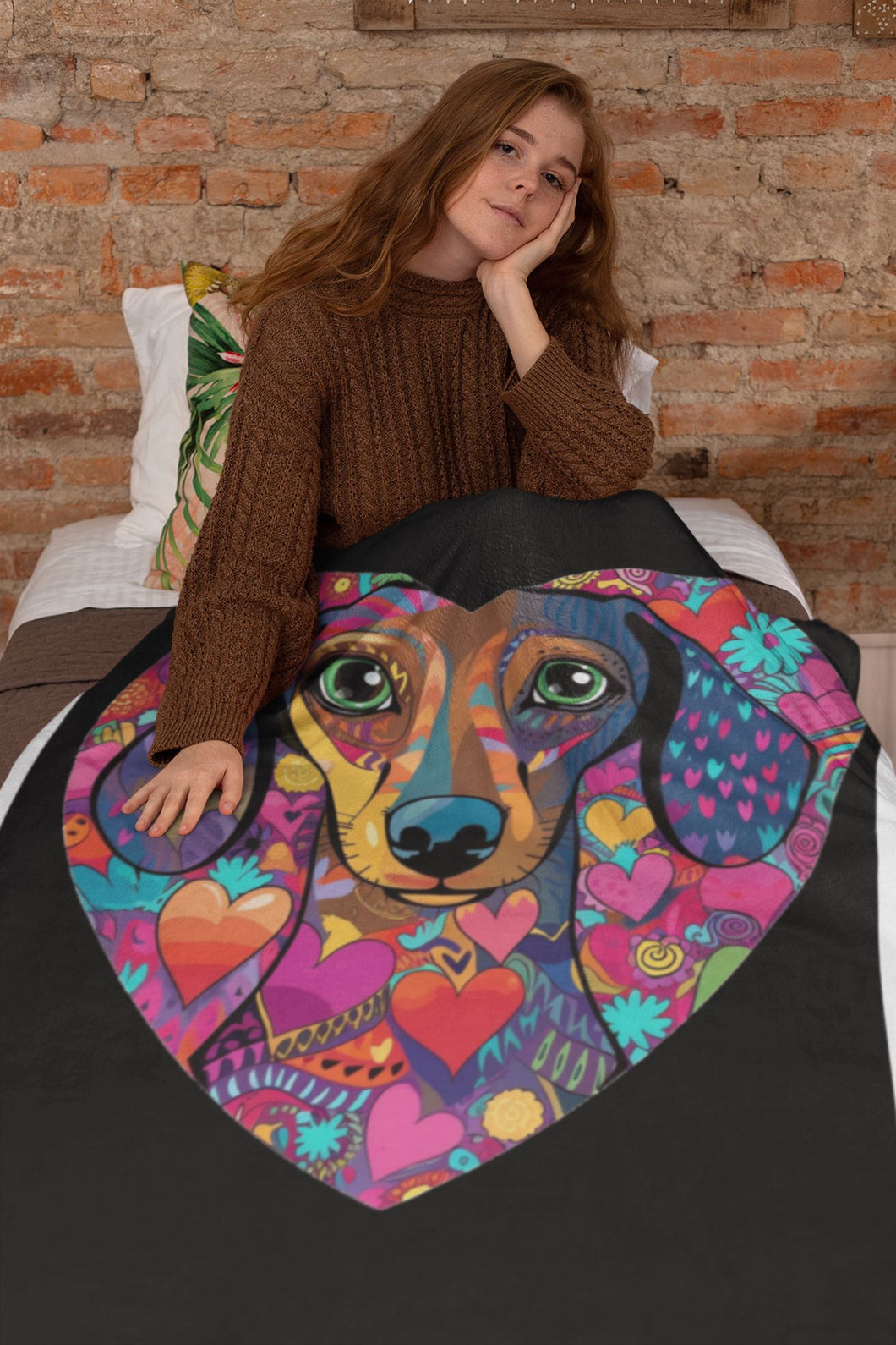 Image of a lady wrapping herself in a beautiful dachshund blanket
