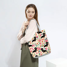 Load image into Gallery viewer, Image of a lady carrying Dachshund tote bag in a most adorable Dachshund in bloom design