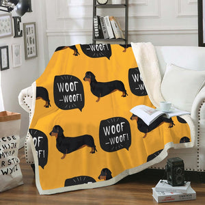 Image of a weiner dog throw with black and tan dachsunds with woof woof text