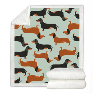 Image of a dachshund print blanket with tan and black and tan dachshunds design