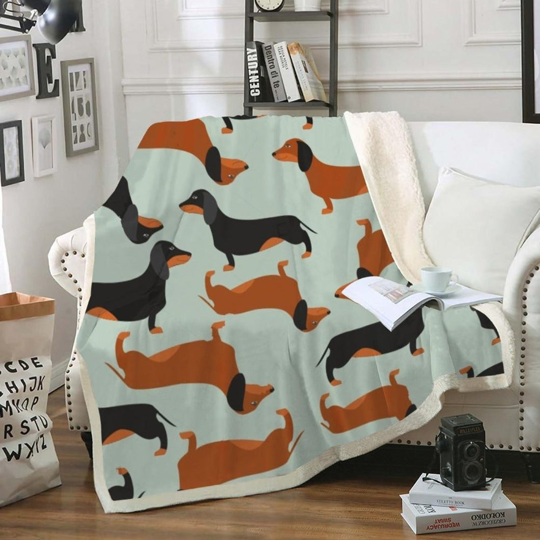 Image of a dachshund blanket with tan and black and tan dachshunds design