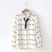 Image of a Dachshund shirt in the color white with infinite Dachshunds design, hanging in a hanger