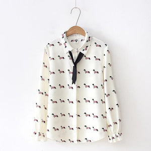 Image of a Dachshund shirt in the color white with infinite Dachshunds design, hanging in a hanger