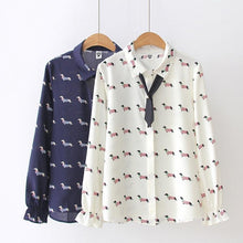 Load image into Gallery viewer, Image of two Dachshund shirts in the color white and navy blue with infinite Dachshunds design, hanging in a hanger