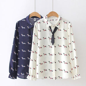 Image of two Dachshund shirts in the color white and navy blue with infinite Dachshunds design, hanging in a hanger