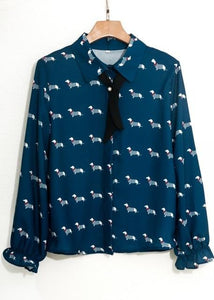 Image of a girl wearing Dachshund shirt in aegean blue color with infinite Dachshunds design