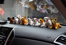 Load image into Gallery viewer, Row of dog bobbleheads on a car dashboard