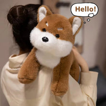 Load image into Gallery viewer, Person holding a plush dog toy with a speech bubble saying 'Home!' in a blurred indoor setting