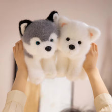 Load image into Gallery viewer, Two plush wolf toys held by hands against a plain background