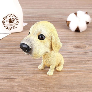 Image of a Labrador bobblehead sitting on the floor