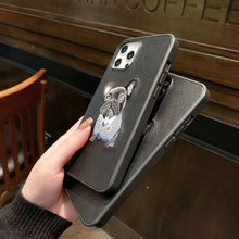 Load image into Gallery viewer, Image of a girl holding two black embroidered french bulldog iphone cases