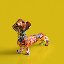 Load image into Gallery viewer, Image of a multicolor extra long dachshund statue in graffiti design
