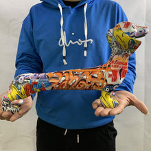 Load image into Gallery viewer, Image of a person holding a multicolor extra long dachshund statue in graffiti design