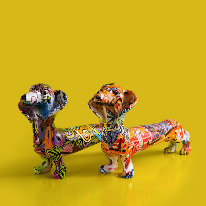 Image of two multicolor extra long dachshund statues in graffiti design