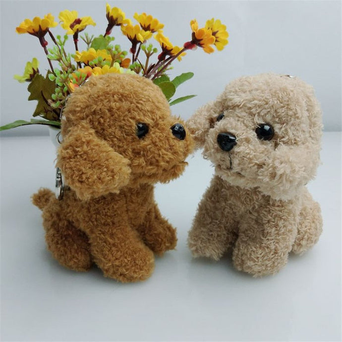 Image of two goldendoodle keychains on a table