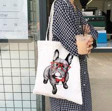 Load image into Gallery viewer, Image of a lady carrying frenchie bag in black frenchie wearing red sunglasses and bowtie design